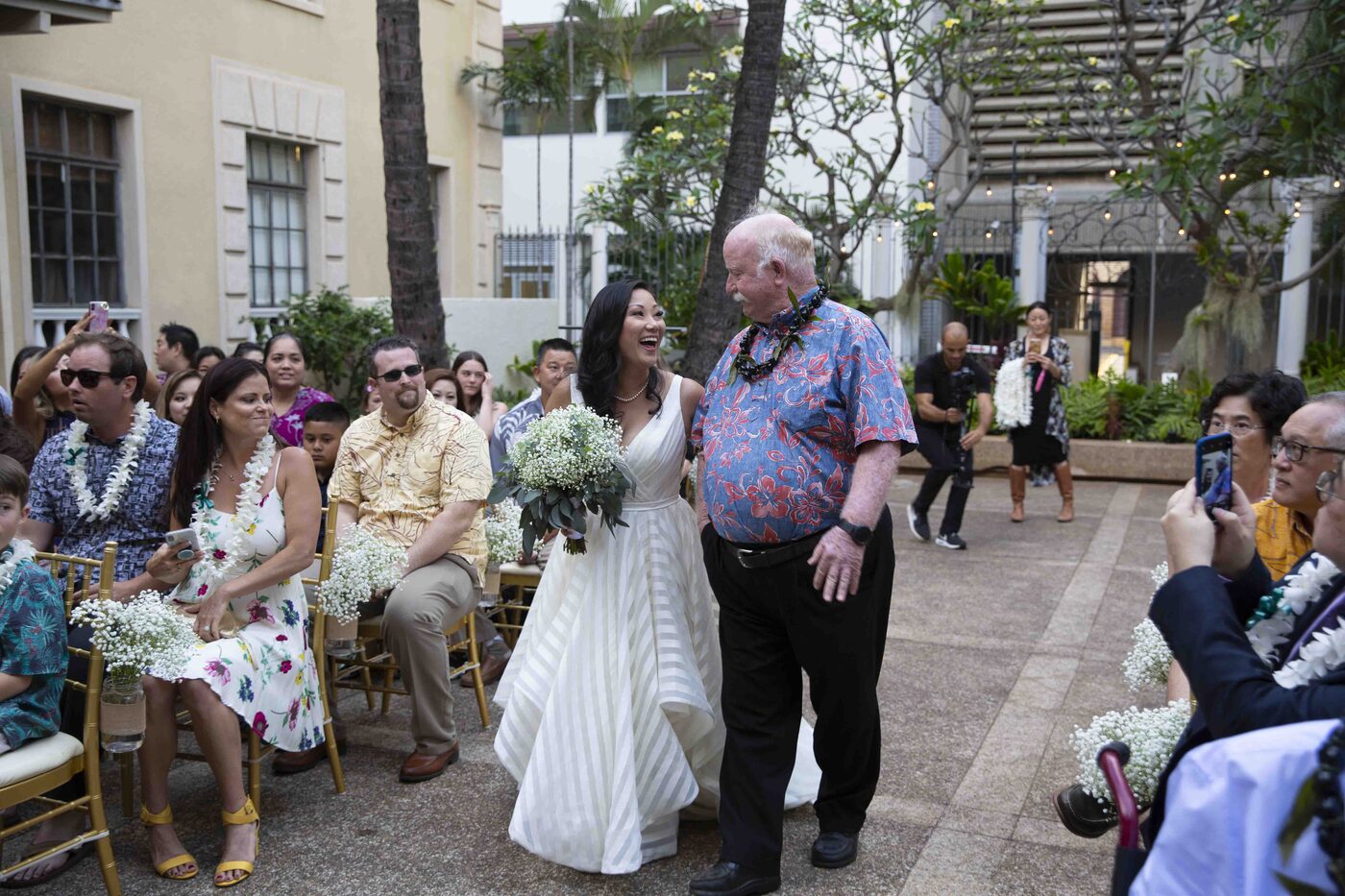 Bride walking down the aisle with her father at a Hawaii wedding
